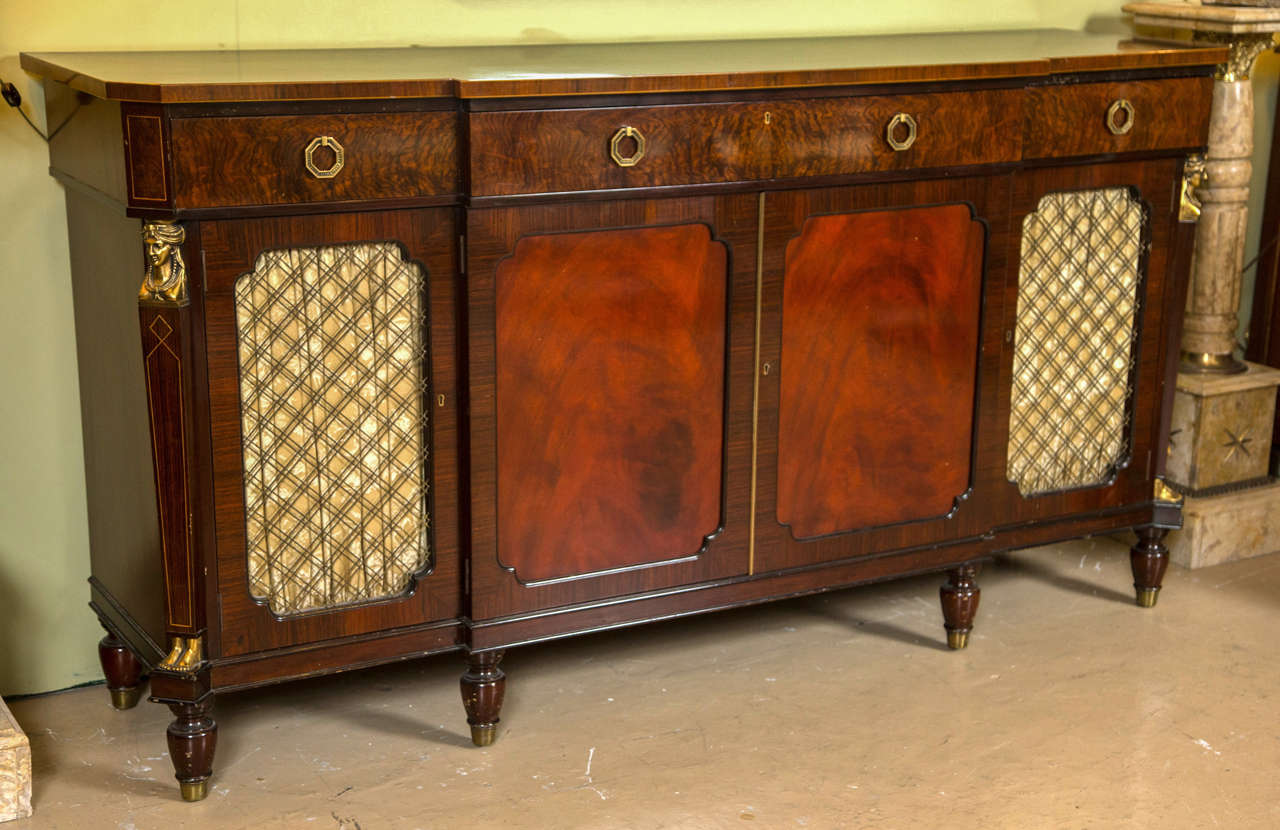 A very fine crotch mahogany sideboard by Schmieg and Kotzian. This rare one of a kind piece was most certainly custom-made. The bronze maiden heads having a square shaped body ending in bronze feet. The over-all casing of a warm crotch mahogany with