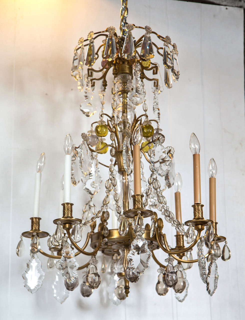 A finely cast bronze eight-arm chandelier. This late 19th-early 20th century chandelier has a wonderfully cast bronze frame with hanging crystal prisms and amber colored mixed crystals. Appears to be in Fine original condition and is presently