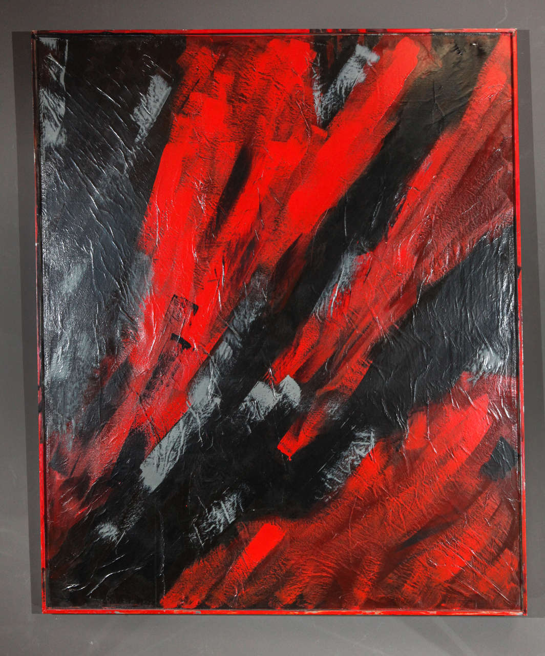Black, Red and Grey abstract oil painting on canvas.  Enclosed in a painted metal frame.