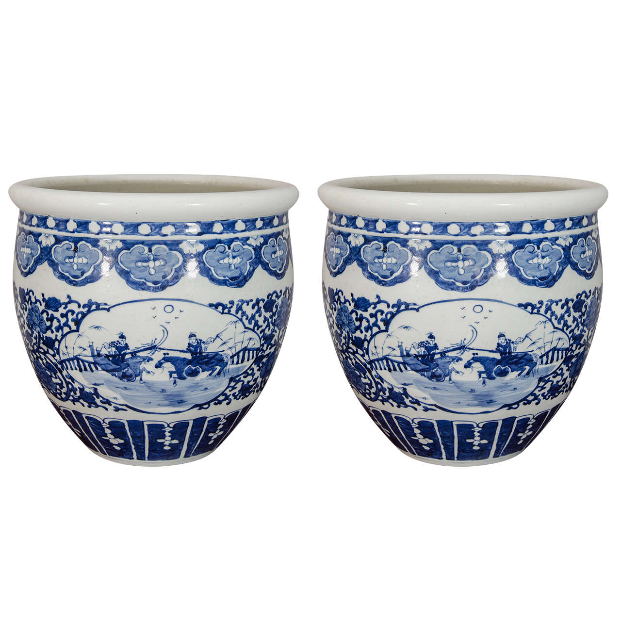 These Qing Guangxu-period fish bowl-style planters are decorated in cobalt blue with vignettes depicting sparring Chinese cavalry soldiers on horseback, surrounded by floral and geometric motifs.