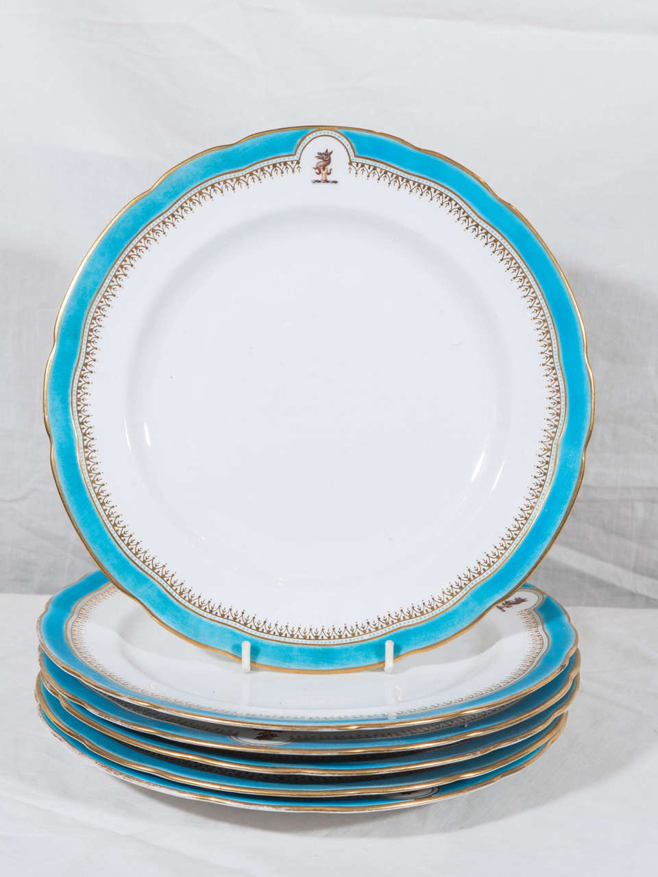A Set of Six Dinner Dishes with Turquoise Border and the Crest of Robertson