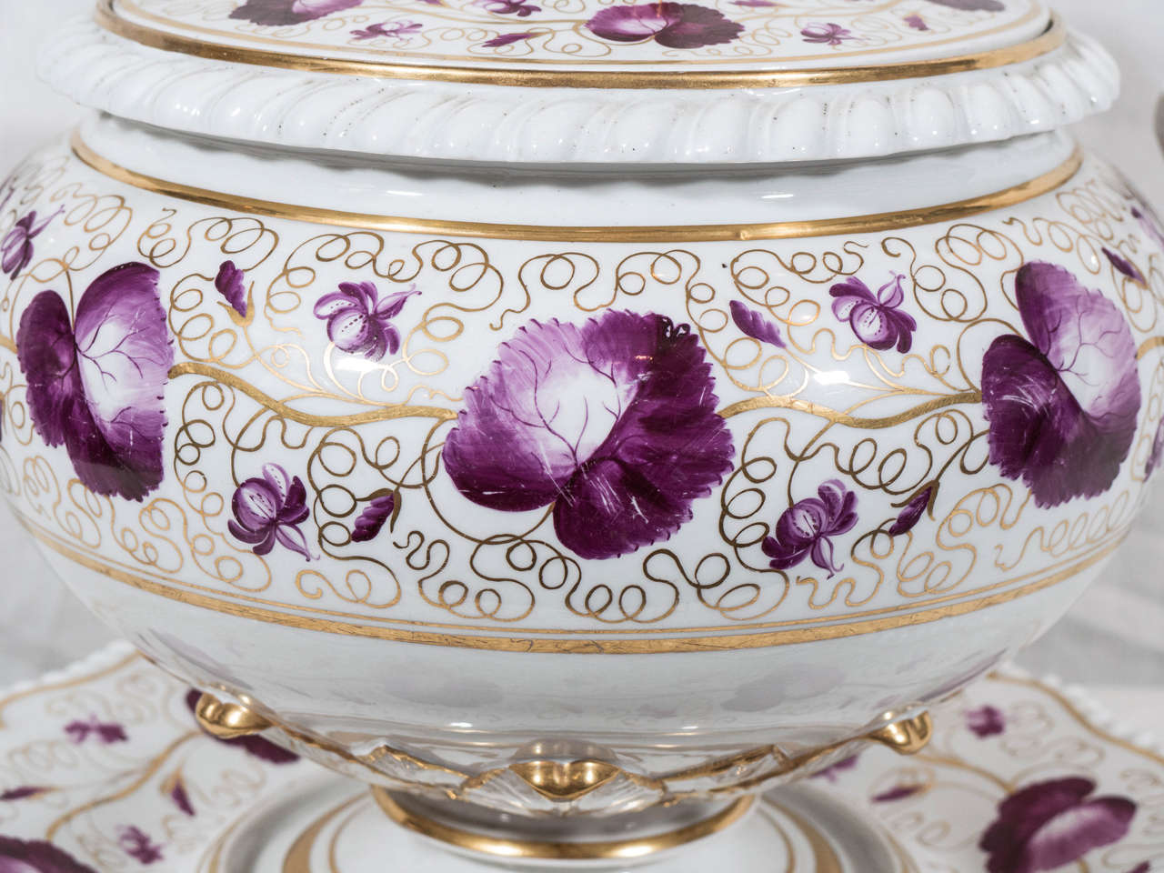 A Flight, Barr, Barr Worcester Porcelain round soup tureen and stand beautifully decorated in purple and gilt with leaves and scrolling vines.The cover and stand both have the unique Worcester gadrooned edge. 
 Marked with the Worcester impressed