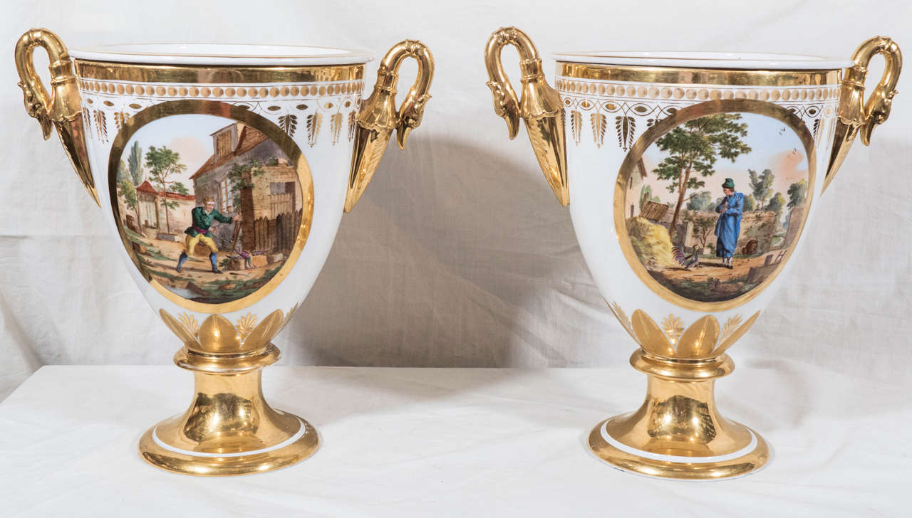 An exceptional pair of French 19th century ice pails with beautiful scenes of lakeside country homes painted in soft colors of pale blue, pink, and green. The quality of the lavish gilding makes this pair an outstanding example of 19th century Paris
