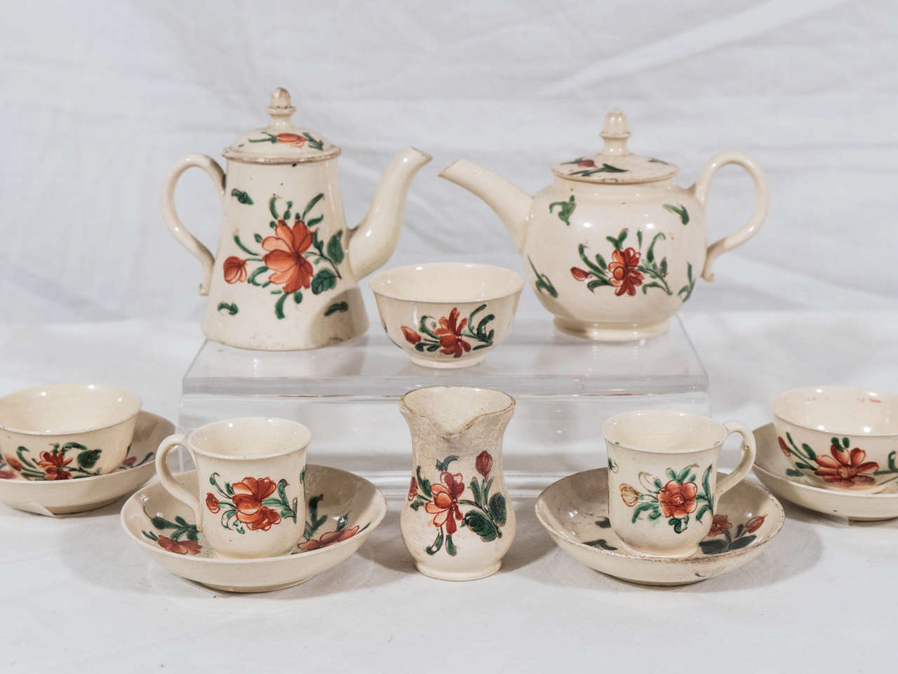 An exceptionally fine 18th century creamware miniature nursery tea-set with a traditional floral design painted in iron red and green. Made in Staffordshire and dating to circa 1770 it is a rare survivor considering it was made for children's play.