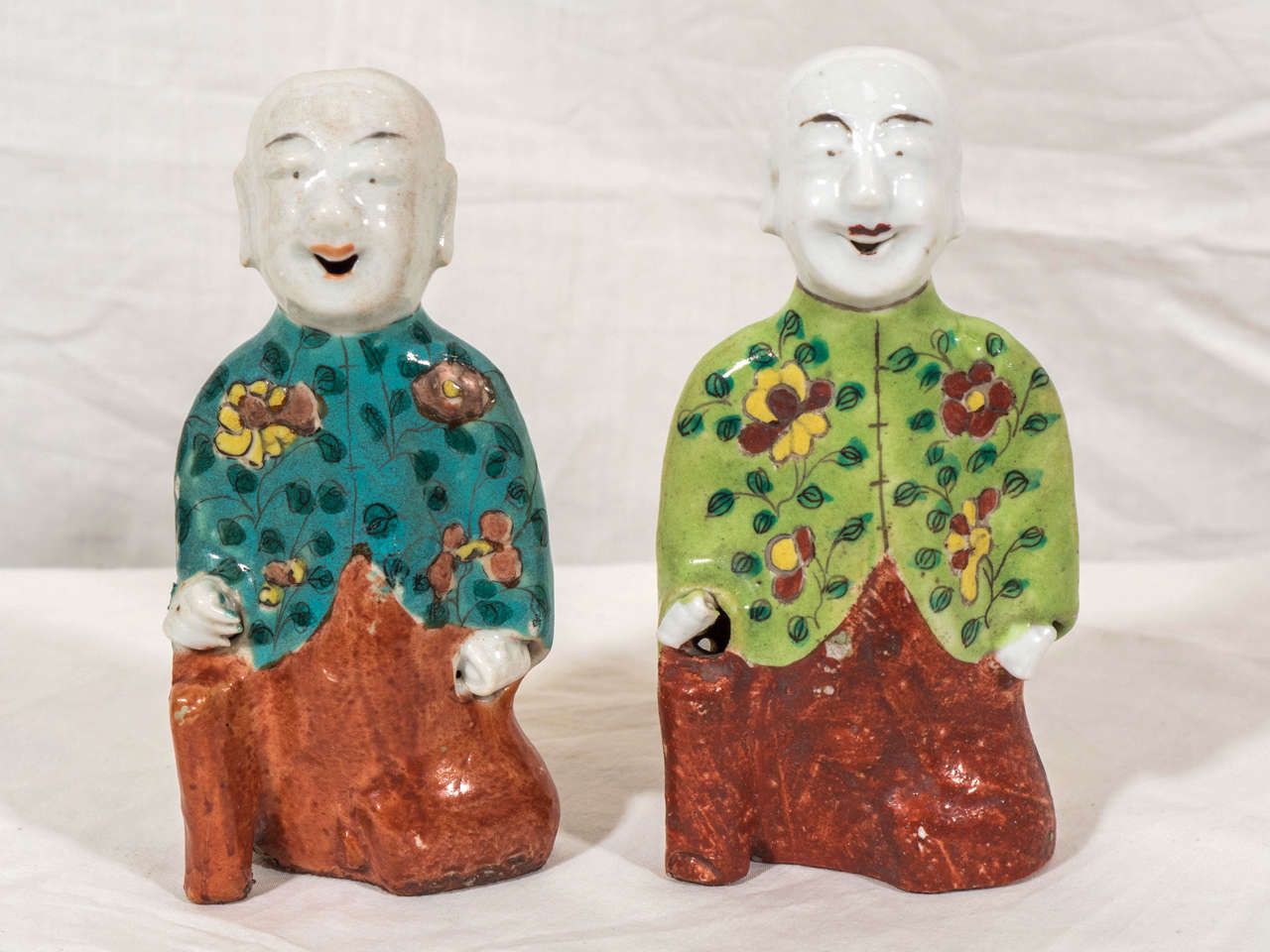A pair of Chinese Export, Famille Rose figures of kneeling 