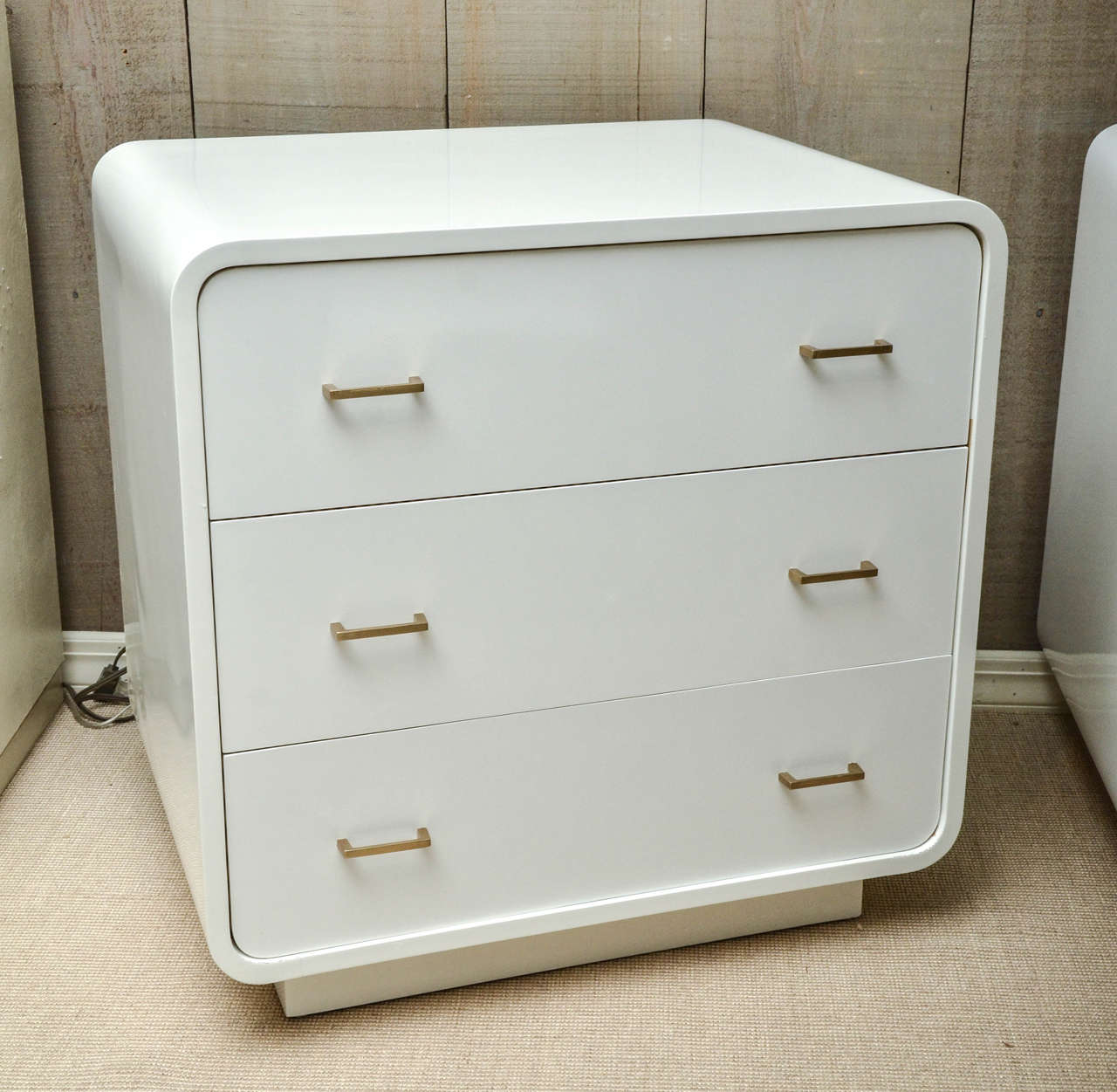 Pair of Mid-Century white lacquer bedside commodes with brass drawer pulls.