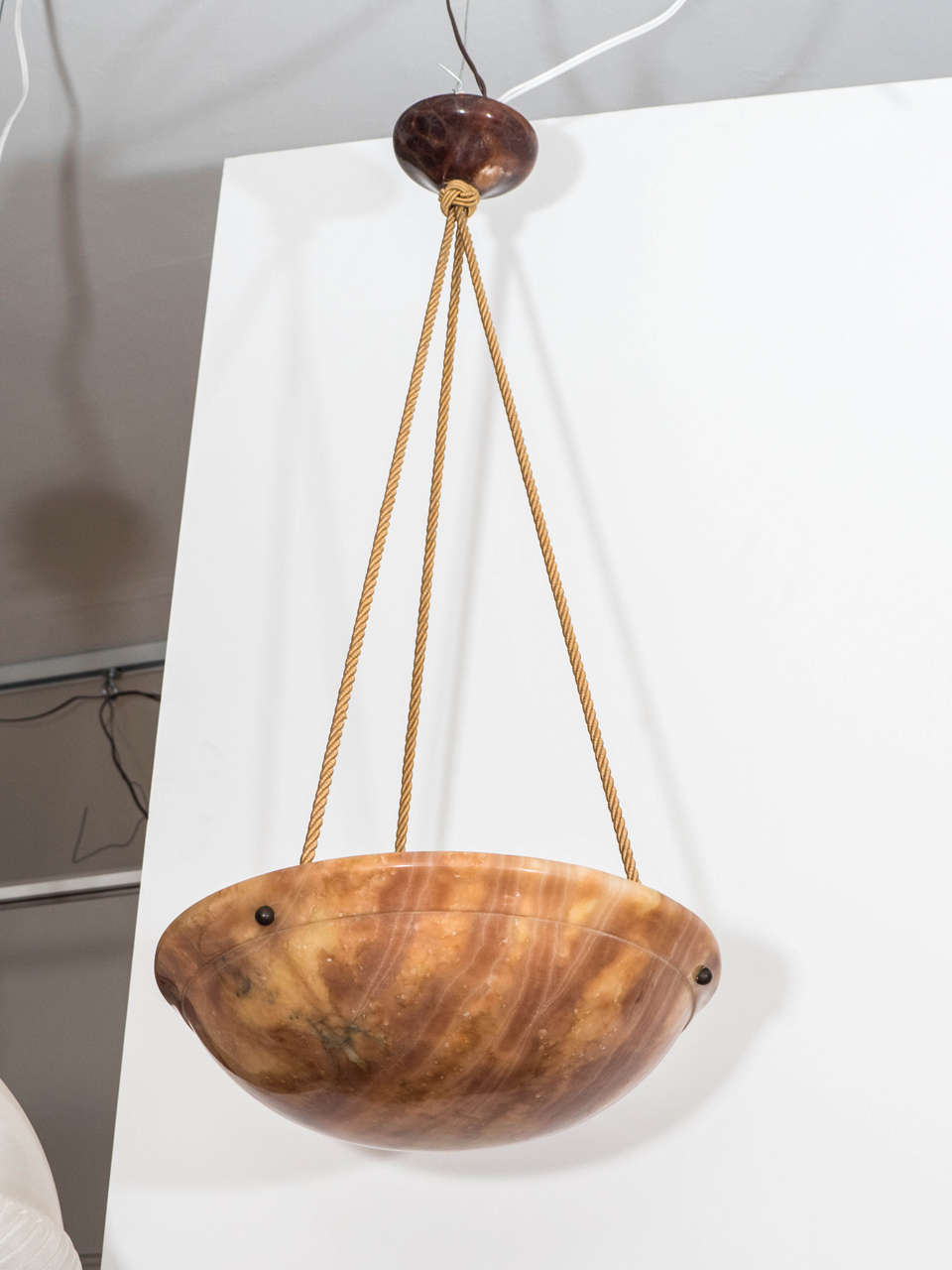 The natural tortoise-toned alabaster bowl displays fossilized reeds throughout, a carved band and an out-turned, graceful rim. Recently rewired, the fixture hold three 60 watt bulbs or three higher wattage LED bulbs.