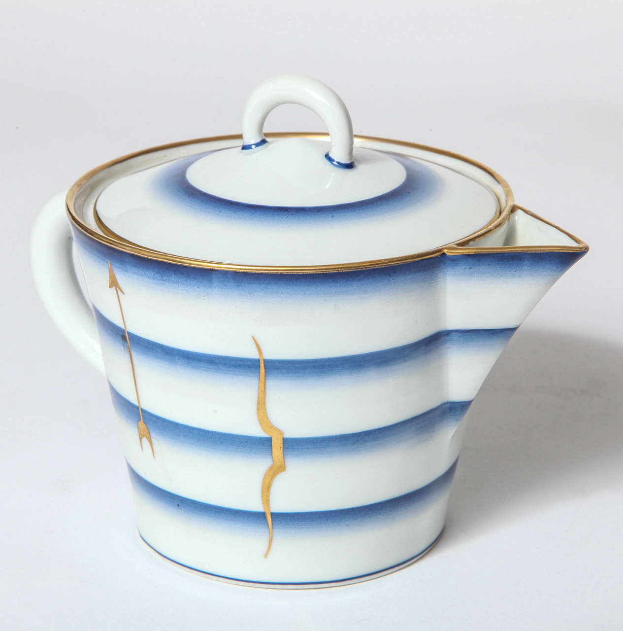 A Gio Ponti designed Italian Art Deco porcelain teapot made by 
Richard Ginori, blue, white and gold stylized blue bands and hand-painted stylized bows and arrows.