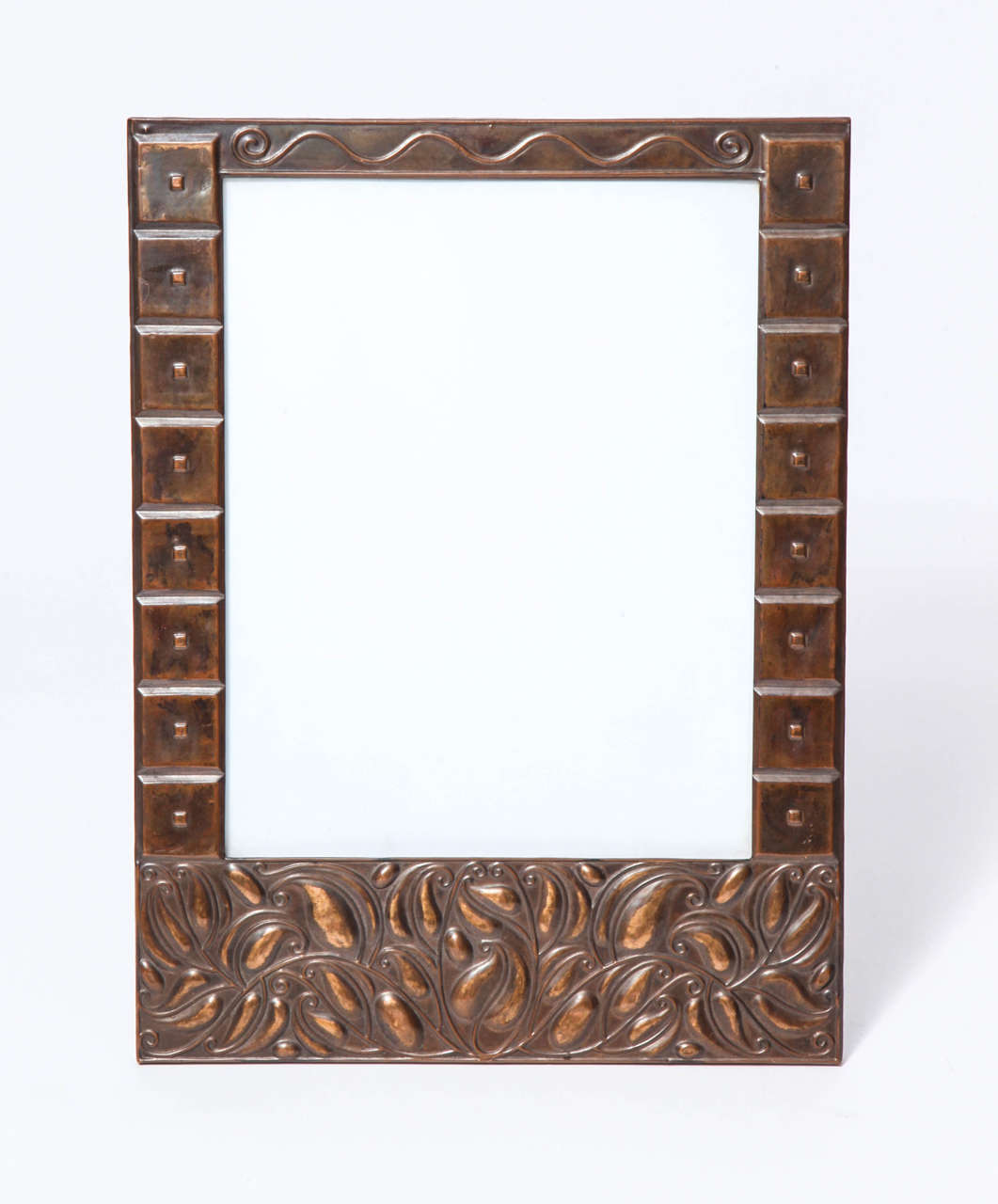 Highly Stylized hand-hammered copper frame with raised secessionist leaves and flowers on the bottom panel and raised geometric designs on the side panels and raised stylized top panel. The backside of the frame is finished as well. It can either be