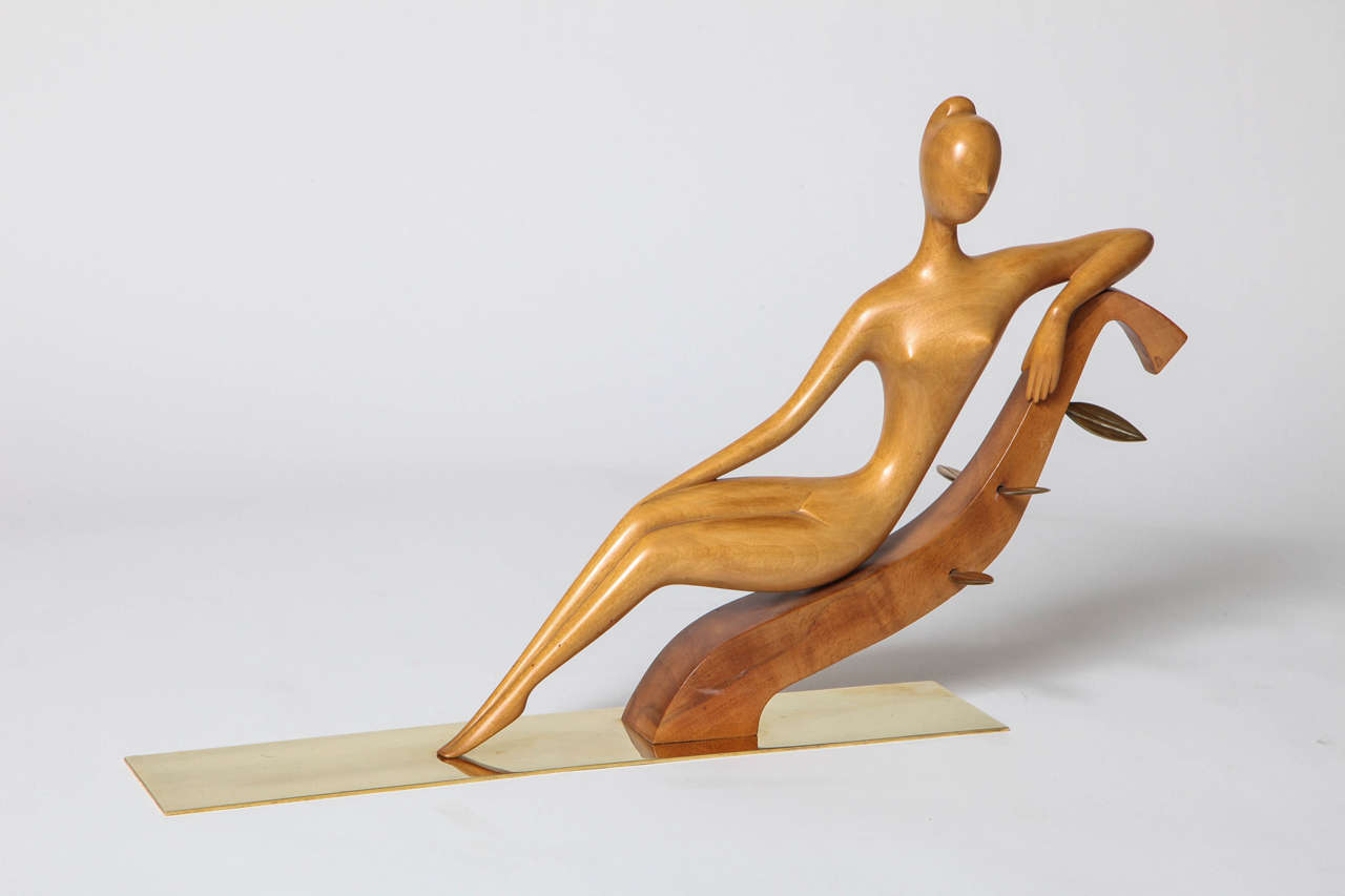 A Franz Hagenauer hand-carved wood reclining nude woman with brass leaves and base, mint condition, circa 1950.