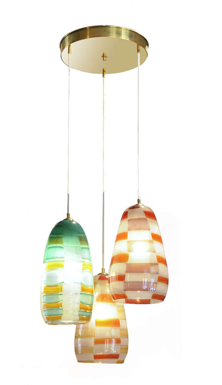 Chandelier made of 3 elements in "pezzato" glass, in different colours.
Brass structure.
Adjustable height