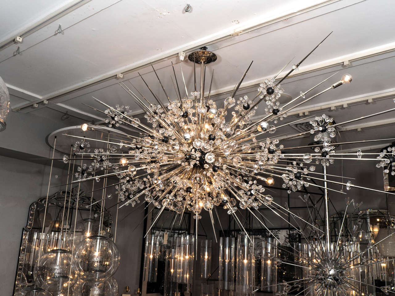Custom Monumental crystal Sputnik chandelier with spikes. One is shown in nickel finish with spikes with ebonized sphere. Customization is available in different sizes and finishes.