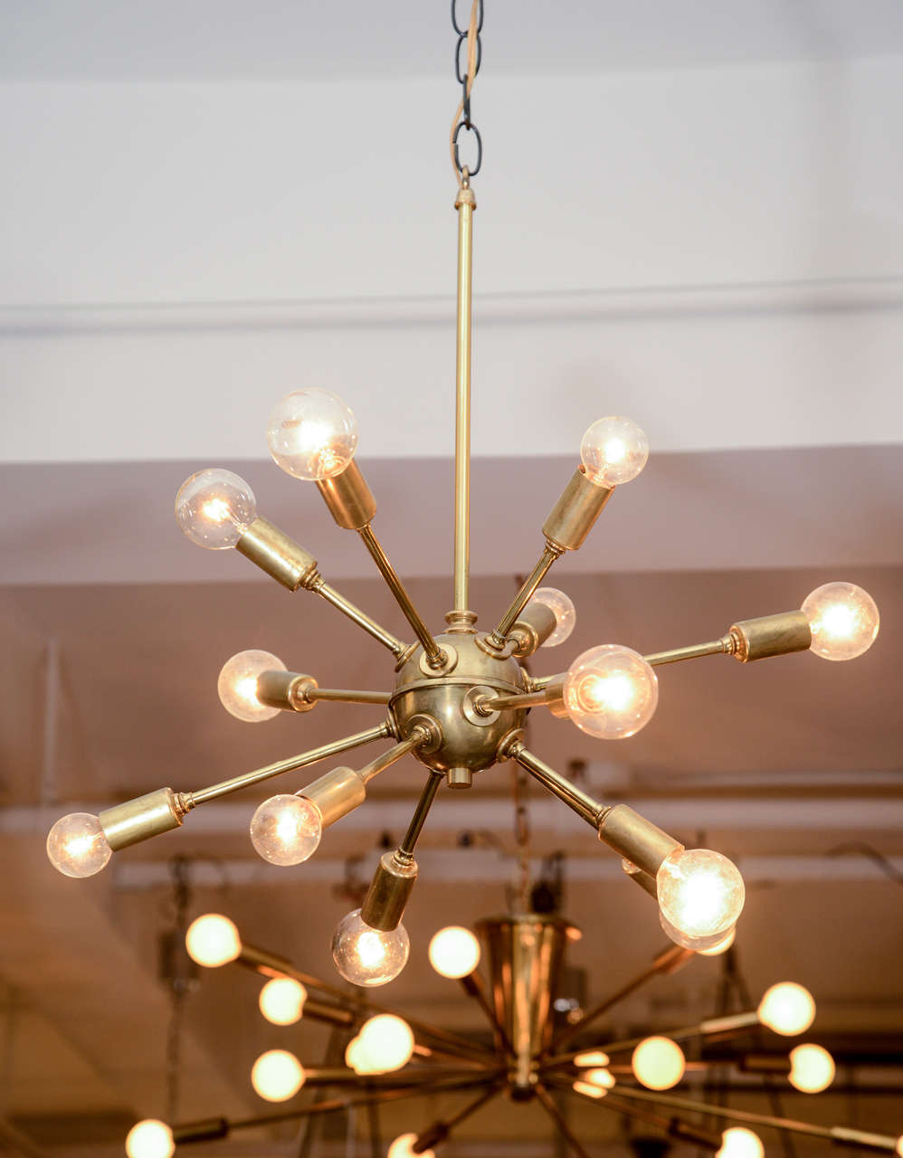 A vintage 10-arm sputnik light fixture in polished brass.  USA, circa 1950.

Fully restored/rewired for the U.S.; fixtures takes 10 candelabra base bulbs, 40 watts max per bulb.

Dimensions:16