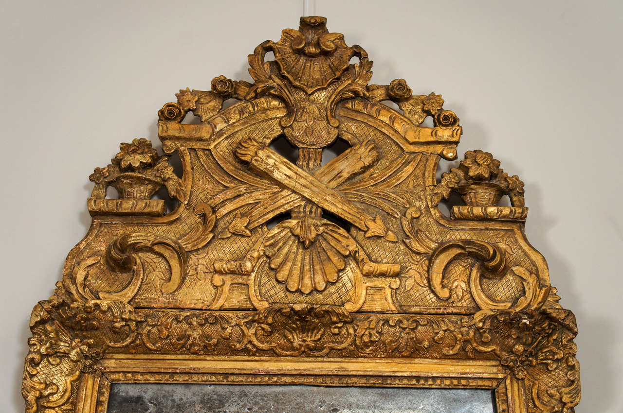 Louis XIV giltwood mirror with original glass.

17th century
Measures: 47