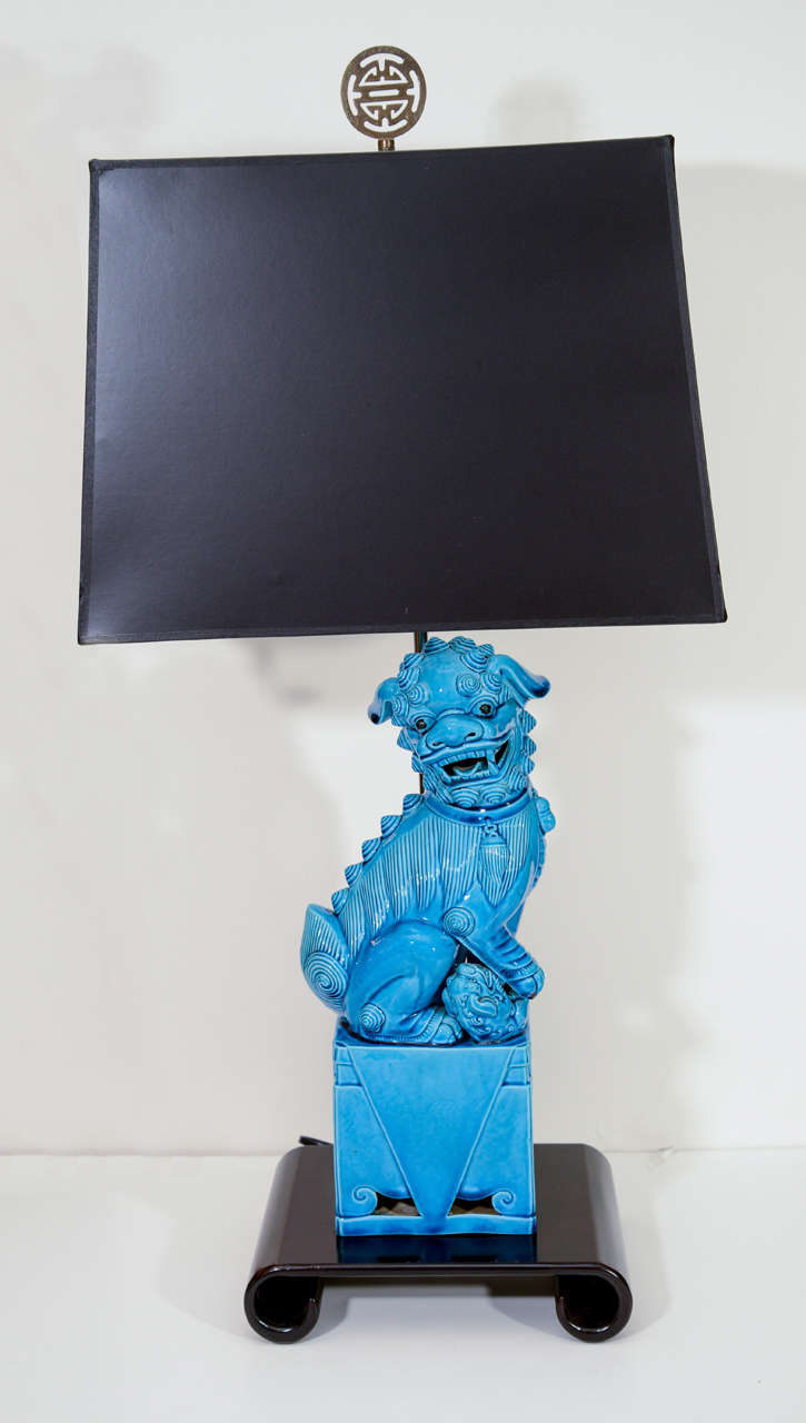 Exceptional pair of Turquoise Blue ceramic Foo Dog lamps on scrolled Rosewood bases with black paper shades.