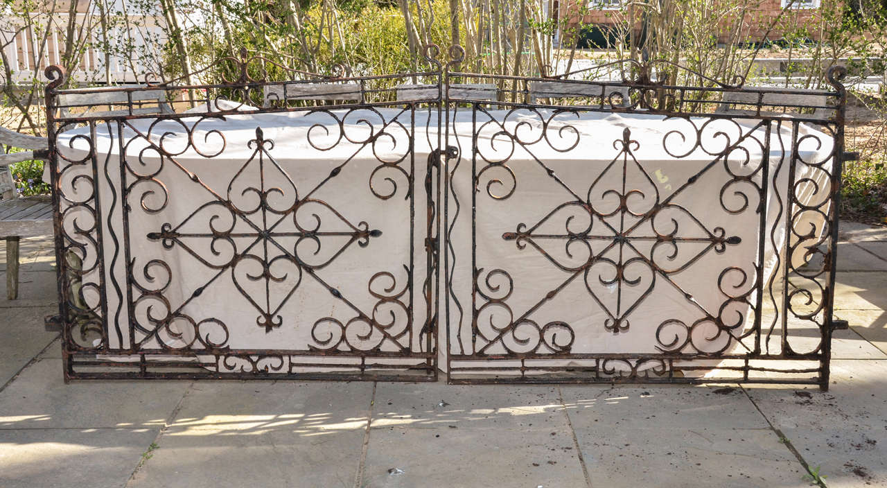 A Pair Of Very Decorative English 19th Cent, Wrought Iron Driveway Or Garden Gates. The Central Pattern Forms A Cross Made Up Of Four Upended Hearts Attached To X Brace-- The Corners Have Decorative Scrolls As Do Both Ends.Very Heavy Wrought