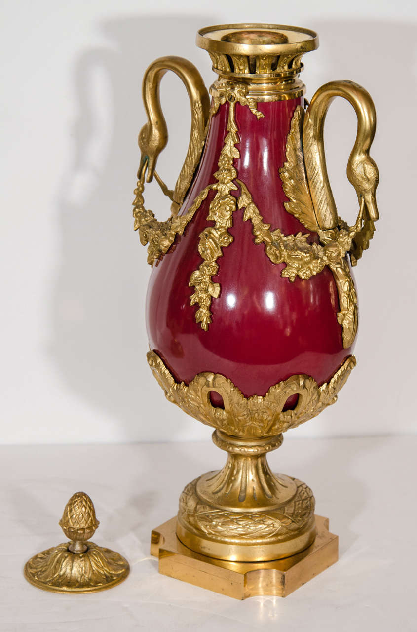 Early 20th Century Pair of Antique French Louis XVI Gilt Bronze and Red Sevres Style Porcelain Urns