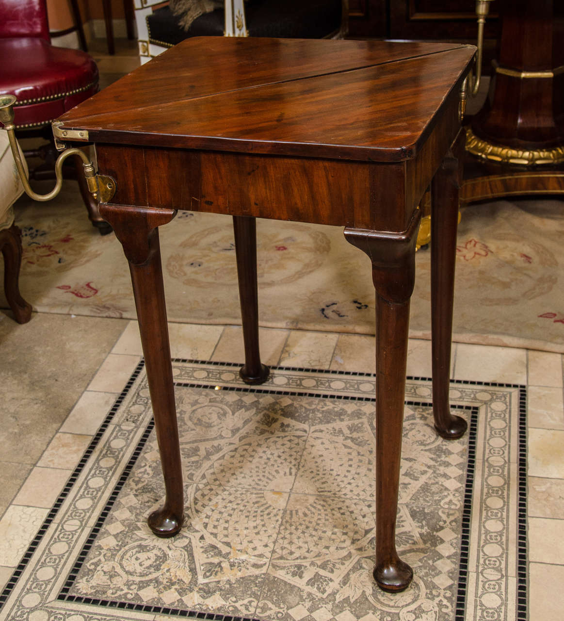 A Rare Queen Anne mahogany triangular triple top games table with brass candle holders, and fitted interiors.