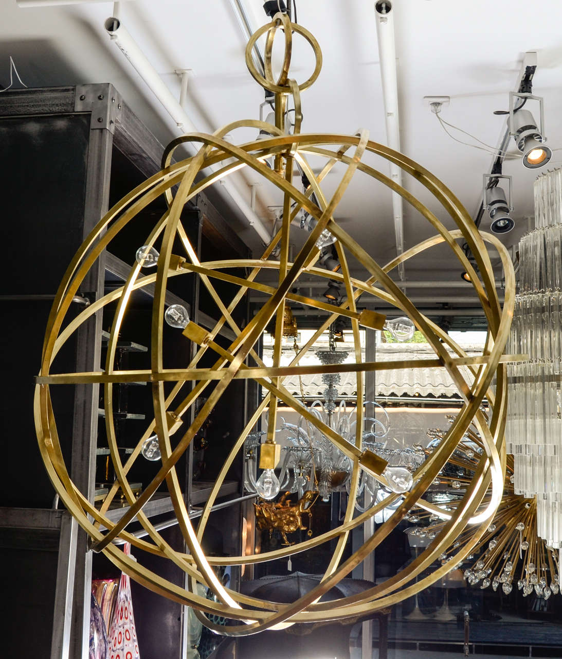Very original brass suspension composed by a sphere materialized by six brass circle that keep an asymmetric seven lights structure. Perfect condition, new electrification. 

Originally a pair, only one is still available (the other one has been