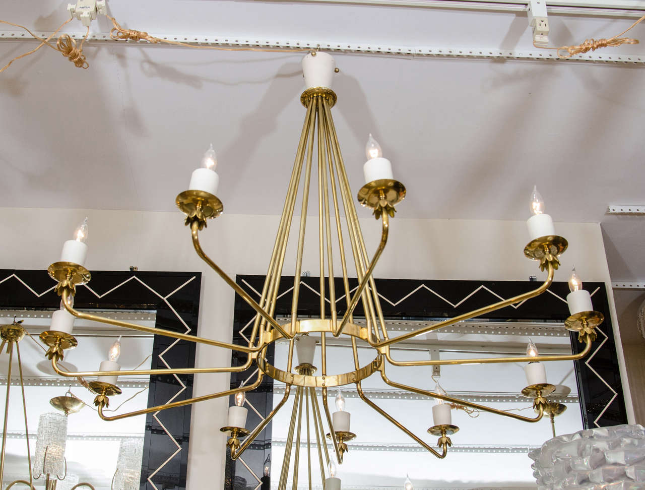 Brass and white enamel eleven light chandelier with decorative brass bobeches in the style of Stilnovo.