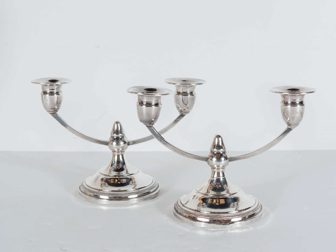This stunning set of 2 Art Deco sterling silver weighted candle stands features a 