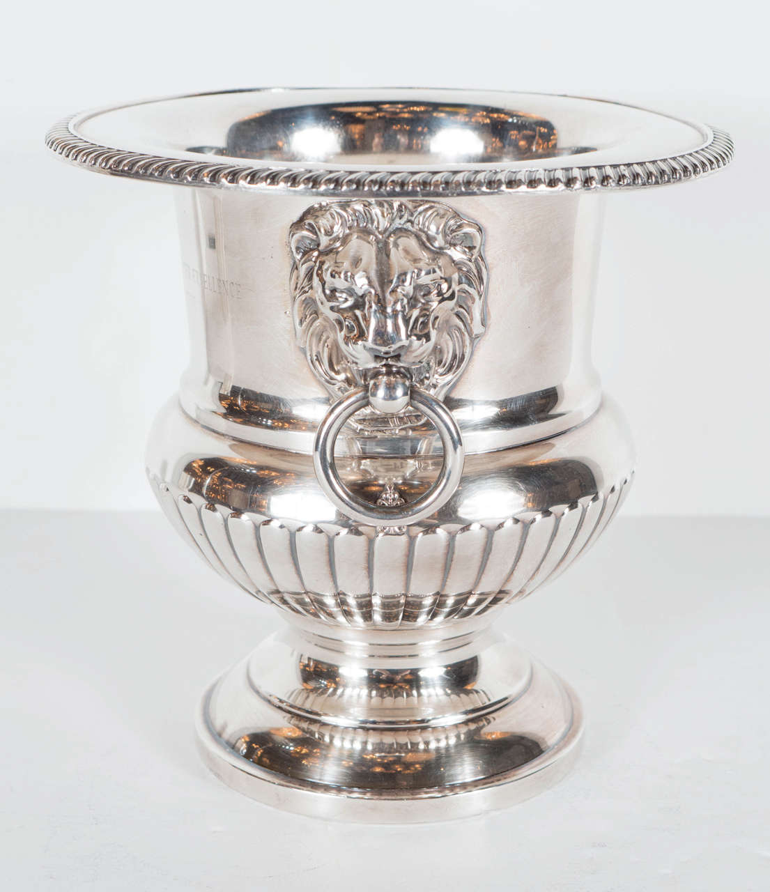 This Neo-Classical silver plate trophy was presented to a fraternity; the J. Edgar Hoover award for excellence engraved on the side (Dated 1965 to 1966). It has a lions figure on each side with etched repoussé detailing on the top rim, fleur-de-lis