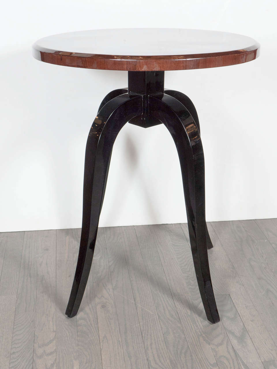 This elegant pair of Art Deco gueridon tables are truly exquisite . They feature a gorgeous starburst inlay design top in book matched walnut, burled carpathian elm in a starburst design pattern.The tops rests on tapered elegant curved  black
