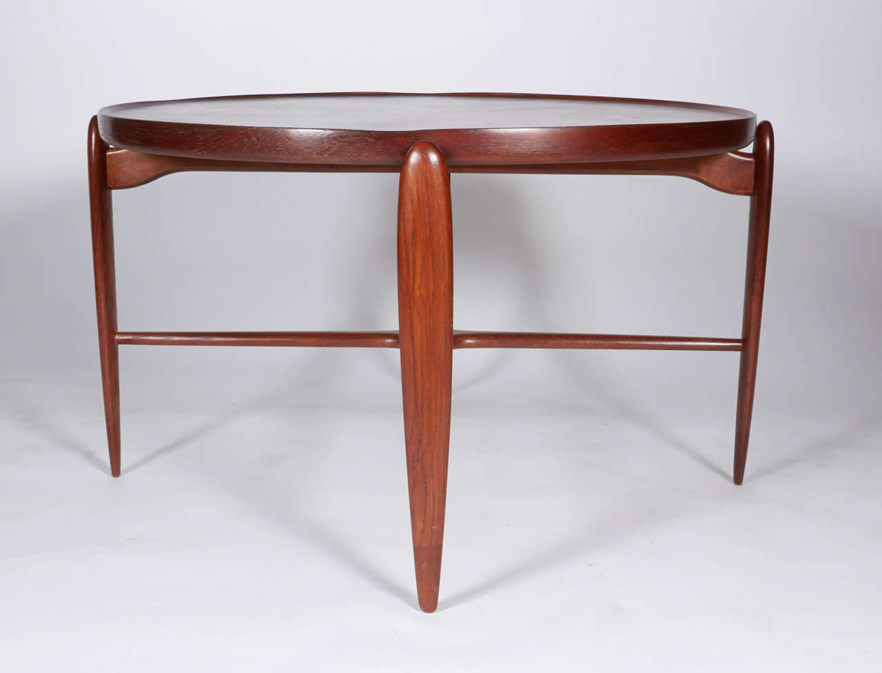 The Danish coffee table boasts simple elegance in its floating (top does not separate) top and tapered sleek legs.