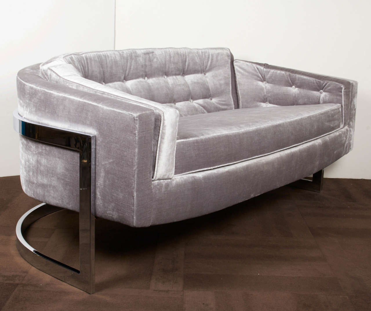 Luxurious sofa/loveseat with a streamline cantilevered frame in polished chrome. Ultra chic design with barrel form exemplifying the best of American Mid-Century design. Newly reupholstered in a lavish grey metallic velvet with tailored biscuit