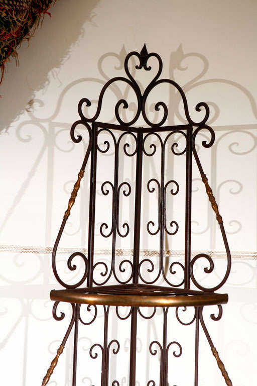 Stylish original Belle Époque French bakery iron corner rack with brass details include scrolled shelf supports with rosettes. Perfect in the kitchen or any room, bakers racks are utilized throughout the home today due to the fact they offer plenty