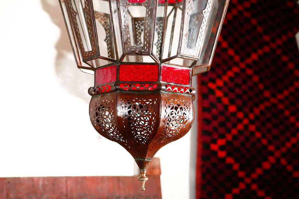 Large handcrafted clear and red glass Moroccan lantern with intricate Moorish details filigree designs on metal.
This Moroccan glass light fixture is wired with a cluster of three lights. 
One side open for easy access inside.
High end