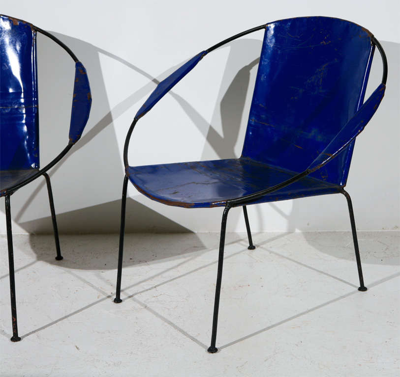 Vintage bright blue oil drum saucer chairs.