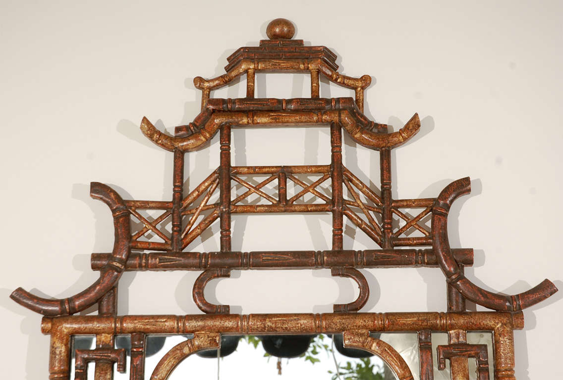 A dramatic pair of Chinese faux bamboo pagoda mirrors of gold brushed wood carved with bamboo detailing.
