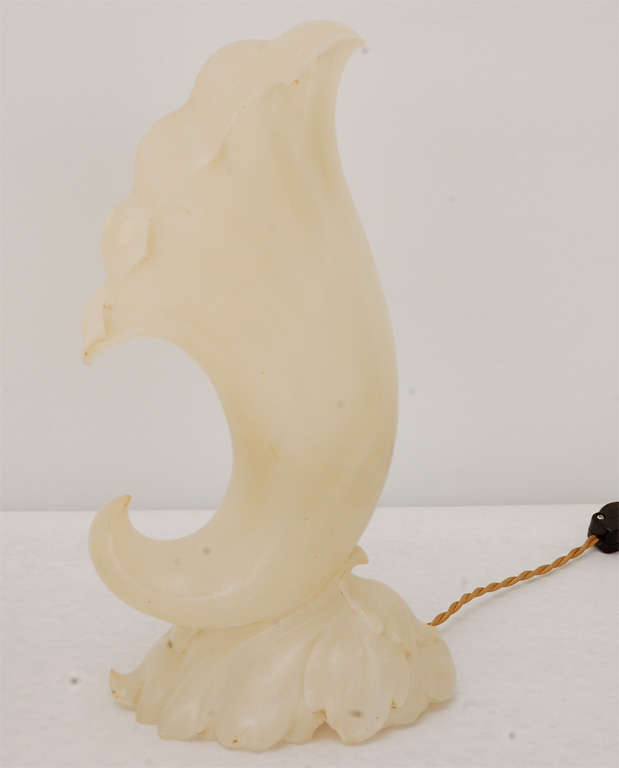 A beautiful pair of carved alabaster lamps in a cornucopia shape with grape leaf detailing around the base. Newly rewired with an on-off switch on the silk twist cord.