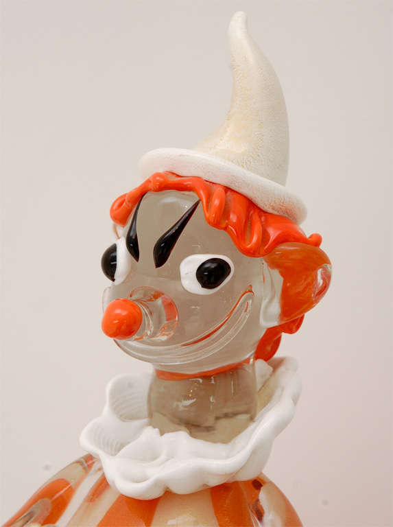 A playful pair of tambourine playing Murano glass clowns in orange and white stripes flecked with gold.  The large clown is really quite big  and very impressive.  The smaller of the duo measures 10