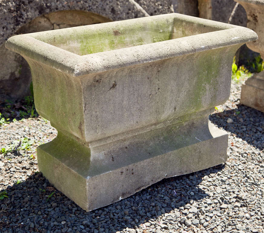 Large and commodious, this heavy cast stone jardiniere has very good weathered surface and light greening. In excellent condition, the planting well measures 24