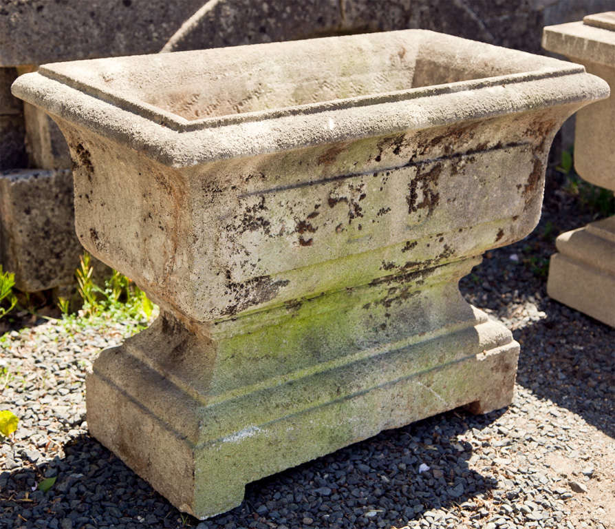 Large and commodious, this heavy cast stone jardiniere has a lovely weathered surface and light greening. In excellent condition, the planting well measures 21