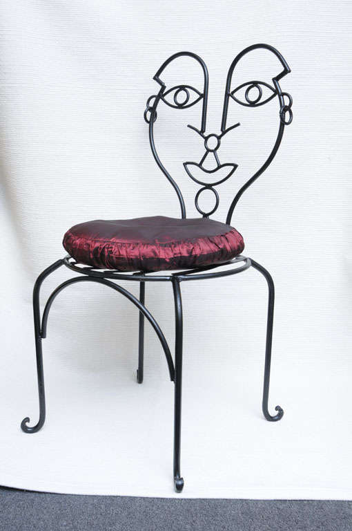 ...SOLD...Beautifully detailed, including loop earrings,  this whimsical chair creation is definitely inspired by the many worked iron designs of John Risley.  With a slight cabriolet leg and a metal slat seat, we've added a satin pouf cushion.  The