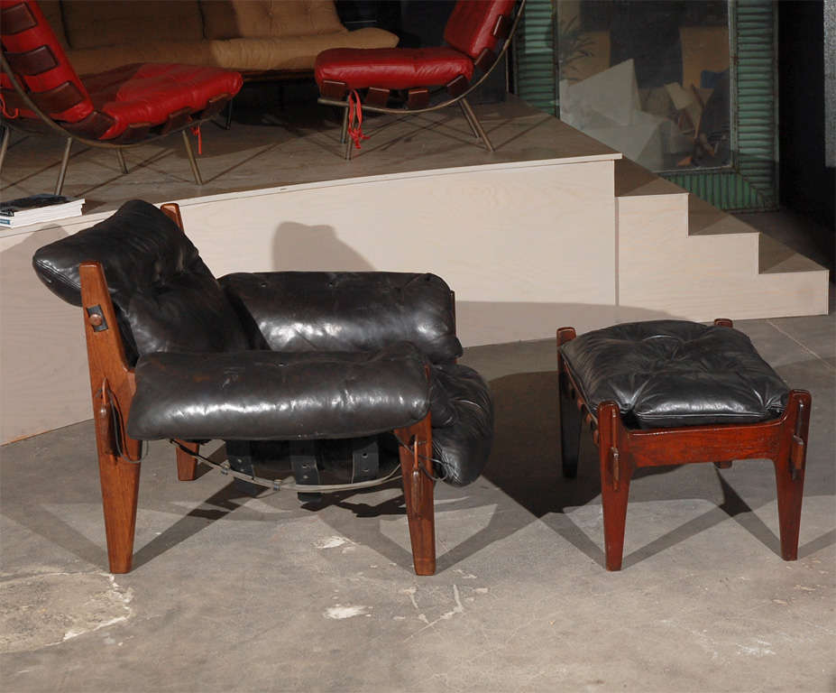 Brazil: pair of Sergio Rodrigues Poltrona Moleca black leather armchairs and pair of ottomans