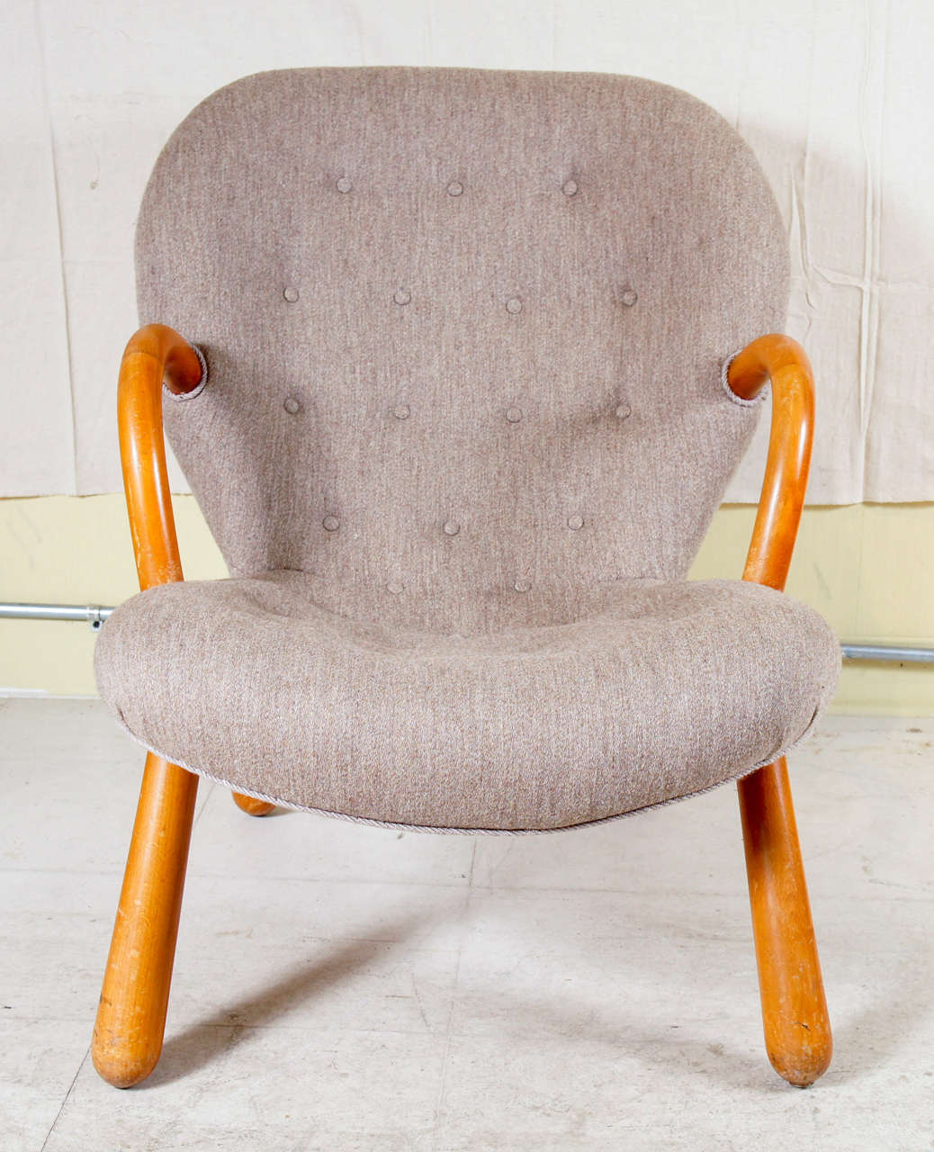 Mid-Century Modern armchair of some renown, by Danish architect, Philip Arctander, designed in 1944 for retail store NY Form A/S, in Copenhagen. Named the 'Muslingestole' or clam chair for its rounded shape, the arms and legs are in beech, and it is