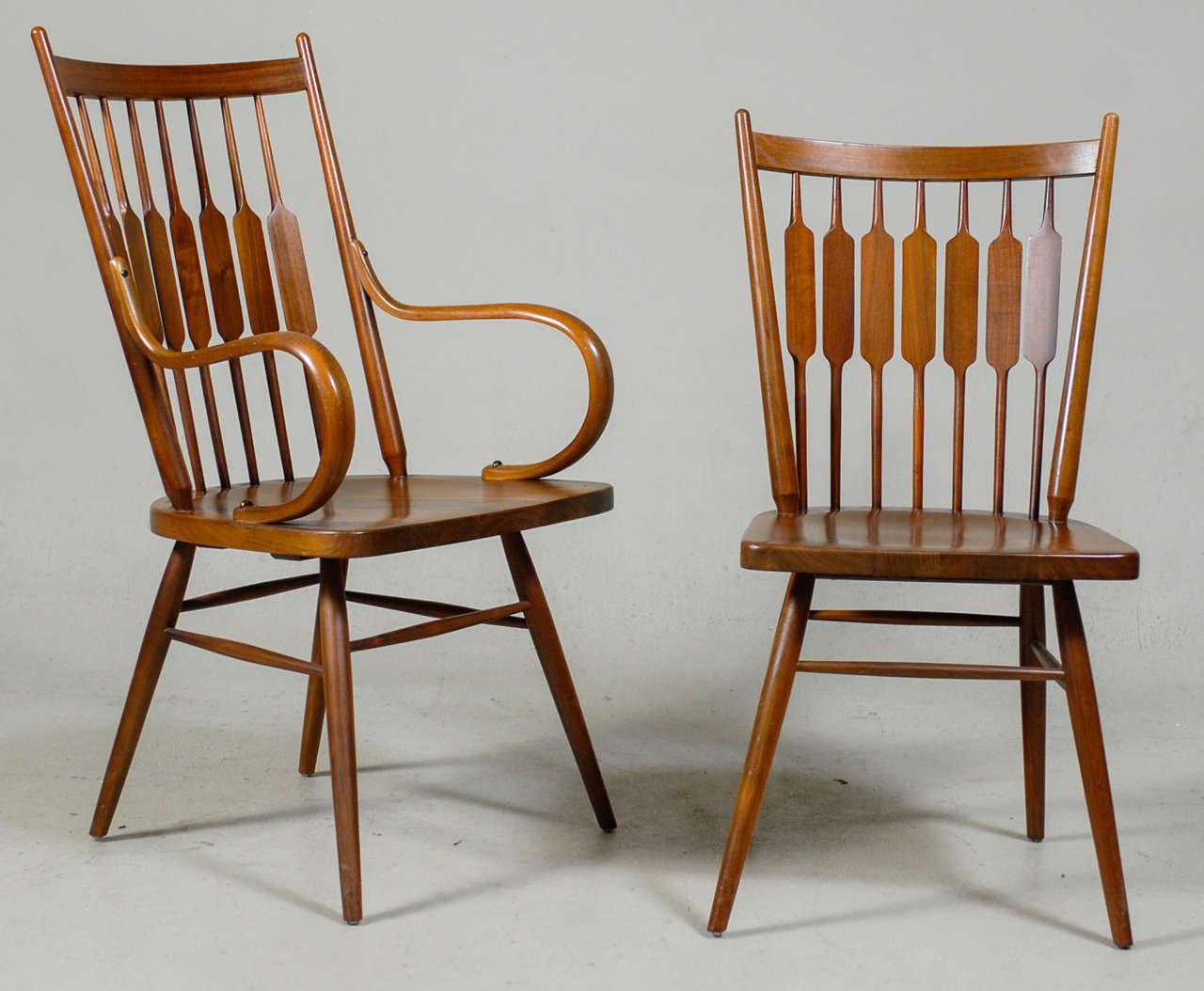 Uncommon set of eight dining chairs designed by Kipp Stewart and Stewart MacDougal for Drexel Furniture.  Set is comprised of six side and two arm chairs.   A blend of early Windsor influences with a more modern Ponti & Nakashima feel.