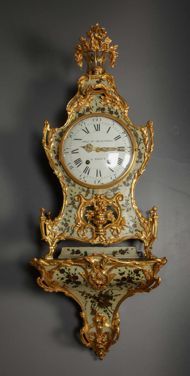 Wall clock with floral motif, gilt bronze basement, round dial marked Pelcat Deslondes à Brives