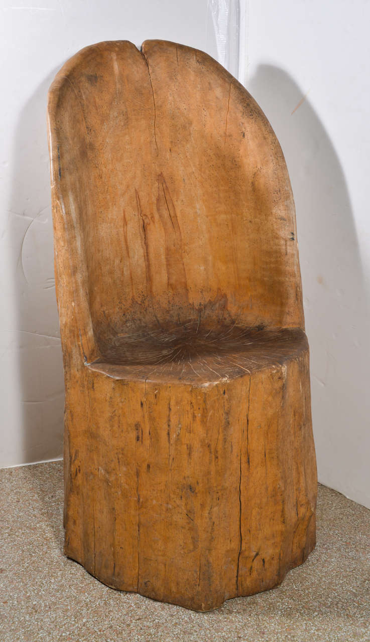 Chair is Carved from a Single Tree. It is in its Natural State,
the Wood is Smooth from Wear..It has Never Been Stained.
It is comfortable to sit in, you do sit  erectly.  It is a wonderful
chair. I believe this chair is Scandinavian.