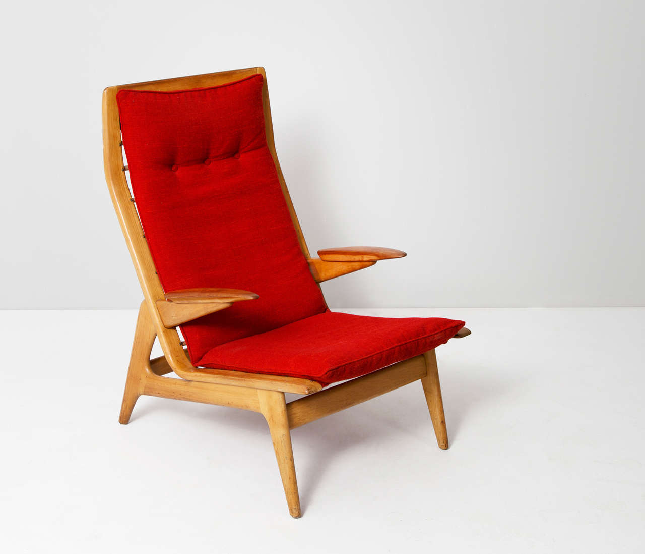 Armchair, beech, teak, red upholstery, Denmark, 1950s. 

This slightly tilted armchairs is constructed out of beech and features teak armrests. All wooden parts have been fully restored and the construction has been checked by our specialized