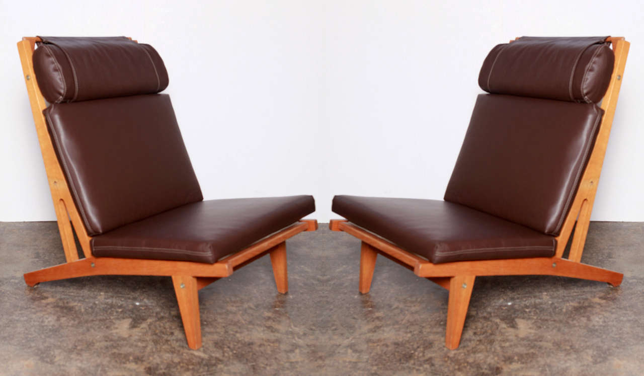 Two classic Hans Wegner Getama lounge chairs in chocolate leather.