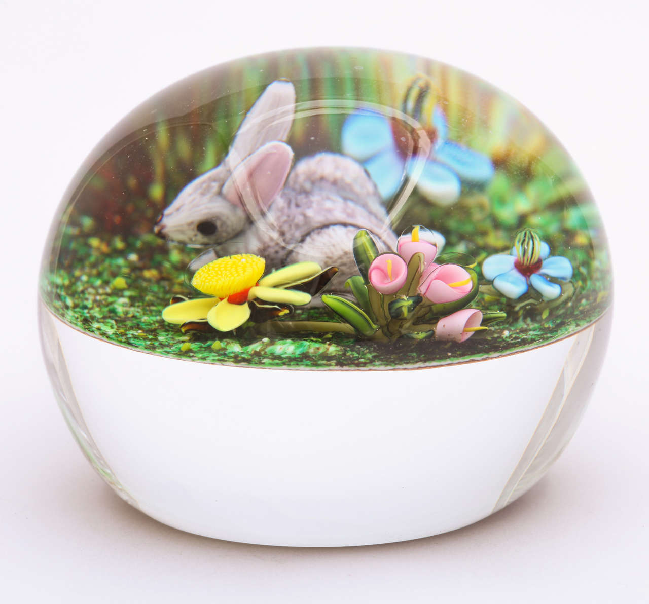 A beautiful Ken Rosenfeld miniature paperweight with a rabbit and flowers on a mossy ground