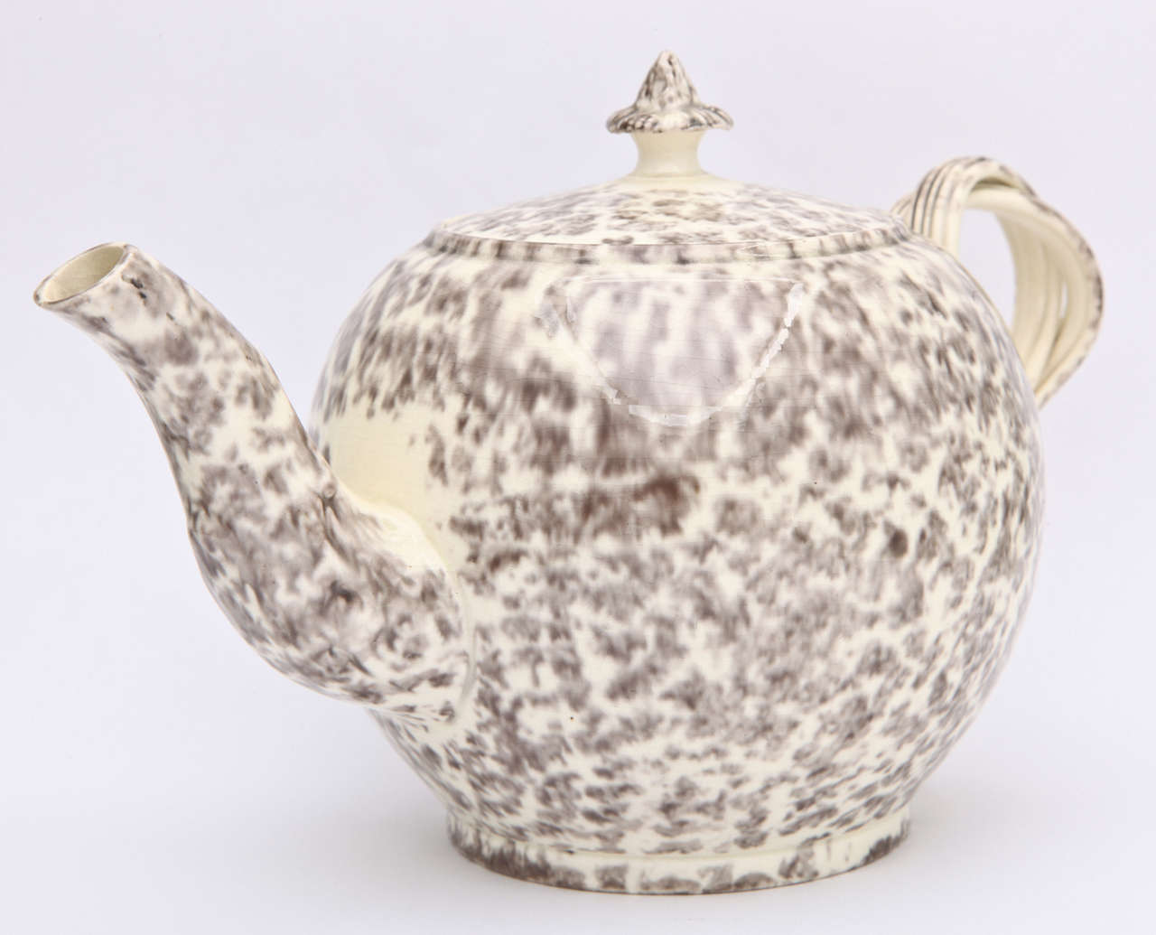 A rare and fine English creamware pottery teapot with flower knop and double strap handles and decorated in gray tortoise glazes