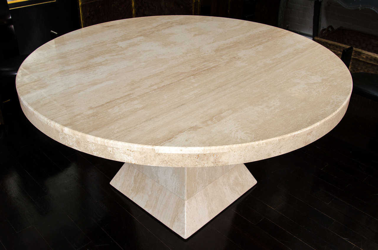 A 60” diameter solid travertine pedestal table. This is a very clean polished version of this table which makes it perfect for dining or as a large entry table.
The top fits in to the base with a secured bracket, but can be removed for easy