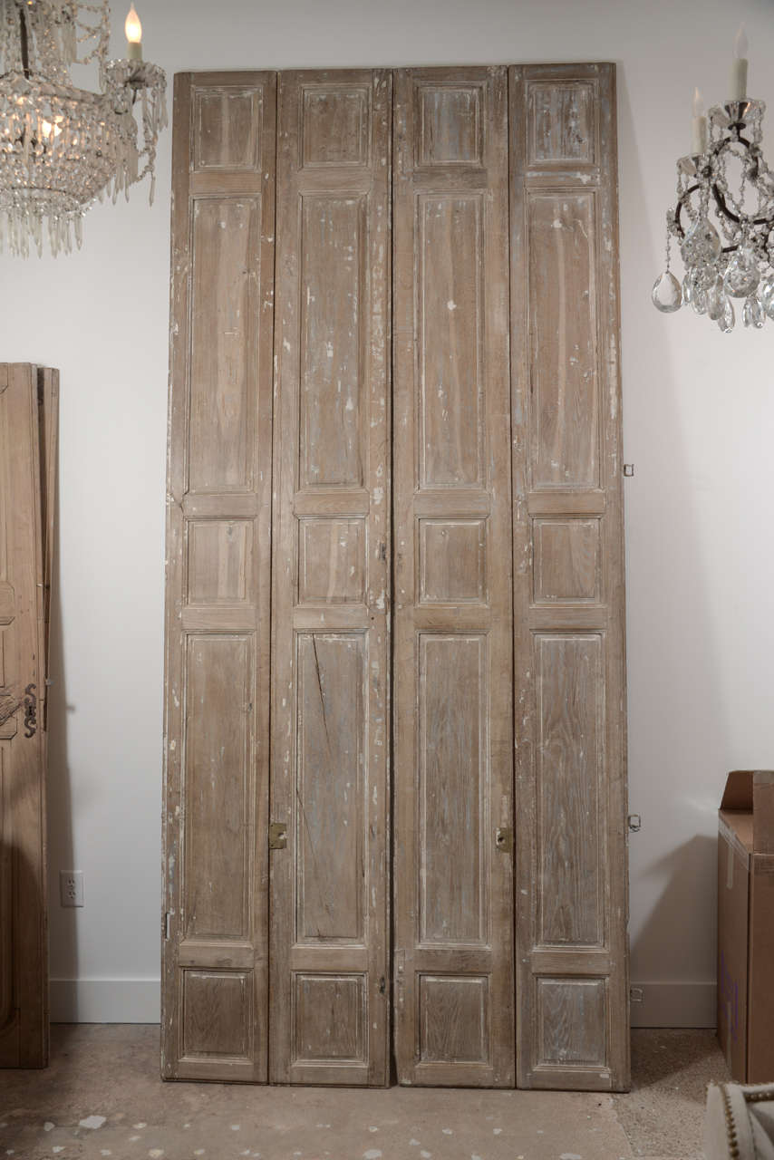 Pair of early 19th century exquisite hand-carved, bleached oak bi-fold shutter doors.