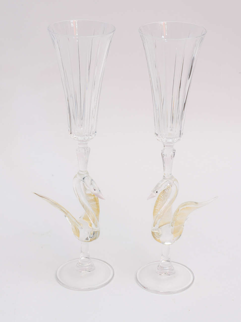 These gorgeous pair of fine crystal Champagne flutes/goblets have the regal swans perched with gold aventurine. They are period pieces.
Their fluted tops ring tradition. Their dramatic size rings regality!
Champagne./wine/water gets even more